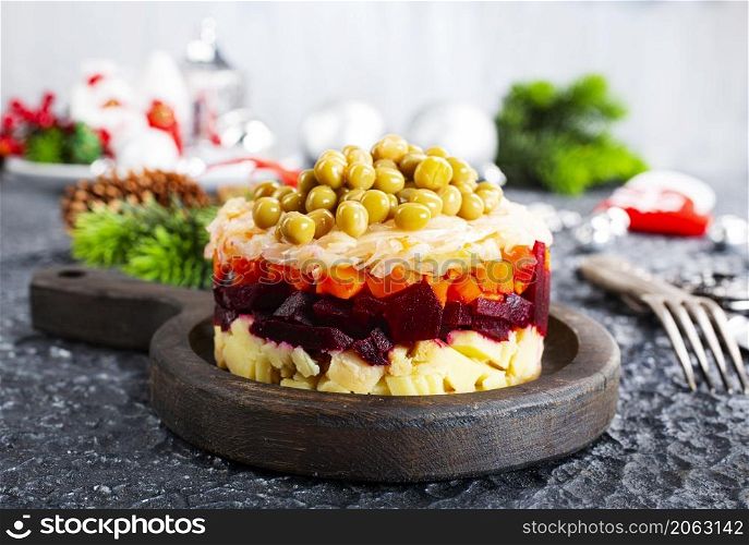 Salad of beets, carrots, potatoes, onions and green peas. Traditional Russian beetroot salad. Vegetarian vegetable salad.