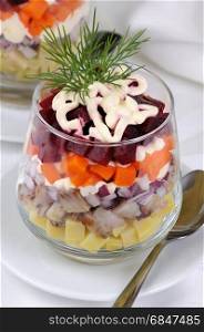 Salad of chopped herring with onions, potatoes, beets, carrots, seasoned with yogurt sauce in a glass