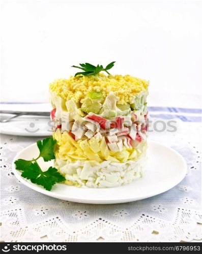 Salad of crab meat, cheese, eggs and green apple in the plate, napkin, dill on background napkins