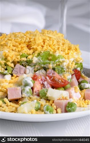 Salad of diced ham, eggs, green peas, salad leaves dressed with yogurt