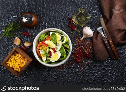 Salad of eggs and corn kernels with vegetables. Close-up