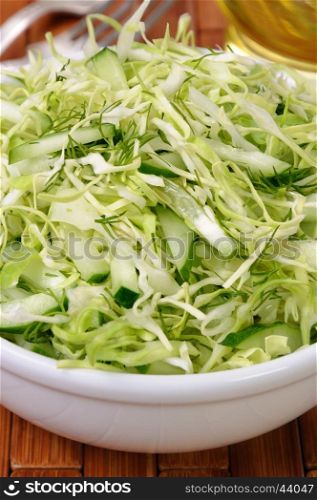 Salad of fresh coleslaw with cucumber and dill