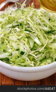 Salad of fresh coleslaw with cucumber and dill