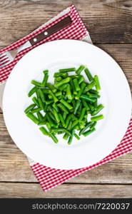 Salad of green beans on white plate. Studio Photo. Salad of green beans on white plate