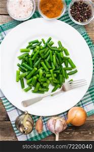 Salad of green beans on white plate. Studio Photo. Salad of green beans on white plate
