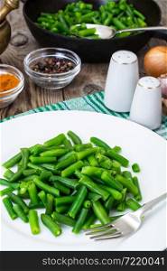 Salad of green beans on white plate. Studio Photo. Salad of green beans on white plate