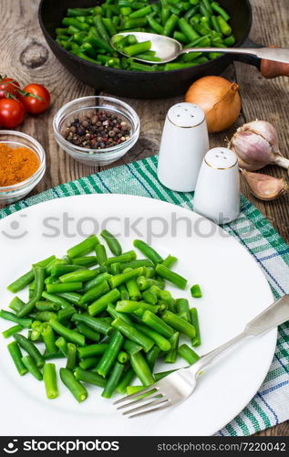 Salad of green beans on white plate. Studio Photo. Salad of green beans on white plate