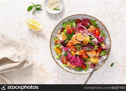 Salad of grilled salmon fillet, tomato and fresh lettuce salad, healthy food,  lunch, top view