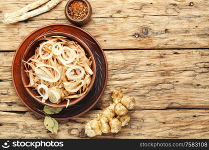 Salad of Jerusalem artichoke and horseradish roots, vegetarian side dish.. Jerusalem artichoke salad