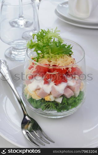 Salad of lettuce with egg, ham, tomatoes, dressed yogurt and cheese