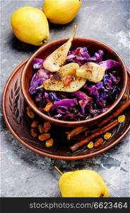 Salad of red cabbage with pear, raisins and cinnamon. Salad of cabbage, pears and spices