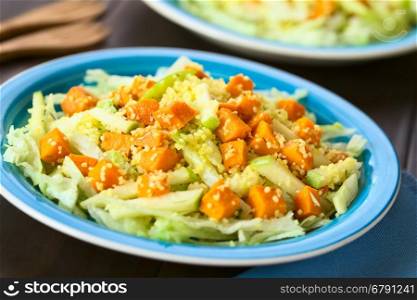Salad of roasted pumpkin, green apple, couscous and iceberg lettuce seasoned with thyme, photographed with natural light (Selective Focus, Focus in the middle of the salad)