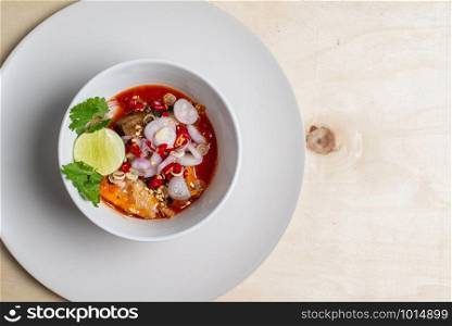 Salad of sardines in tomato sauce in a white cup to mark the image.
