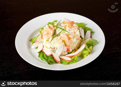 Salad of shrimps, crab meat, cucumbers, apples, potatoes, lettuce, maize, eggs and mayonnaise