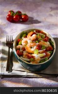Salad of shrimps with squid tomatoes celery inside an oval bowl. Salad of shrimps