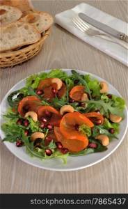 salad of spinach, arugula, lettuce, persimmon, pomegranate and cashews