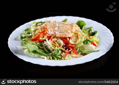 salad of vegetables and meat on black background