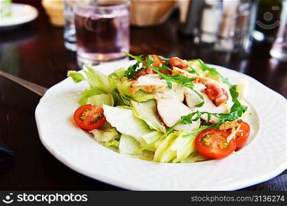 salad of vegetables and slices of chicken meat