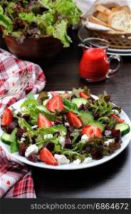 Salad of vinaigrette with strawberries, tender feta and strawberry sauce