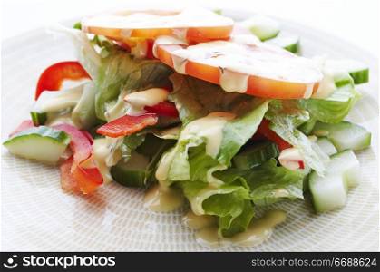 Salad on the plate with dressing