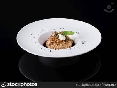 salad puree in a plate on a black background. dish on black background