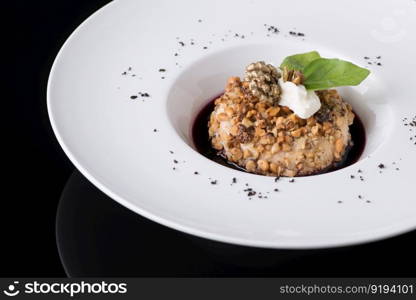 salad puree in a plate on a black background. dish on black background