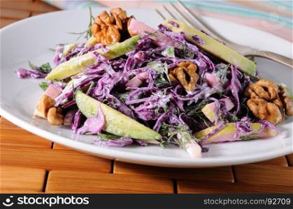 salad red coleslaw with slices of avocado, apple, nuts, parsley, dill seasoned yoghurt sauce