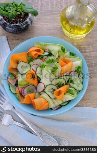Salad ribbon of carrot and zucchini with radish and cucumber