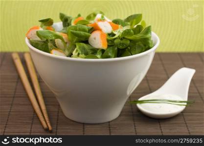 salad surimi and tzatziki. a photo of a cup of salad with surimi and tzatziki cream