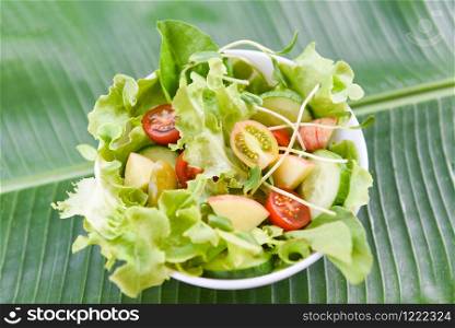 Salad vegetable / salad bowl with fruit and fresh lettuce tomato cucumber on banana leaf healthy food eating concept