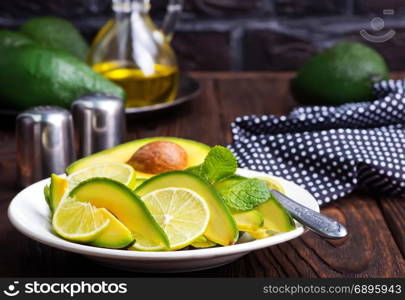 salad with avocado and lime on plate