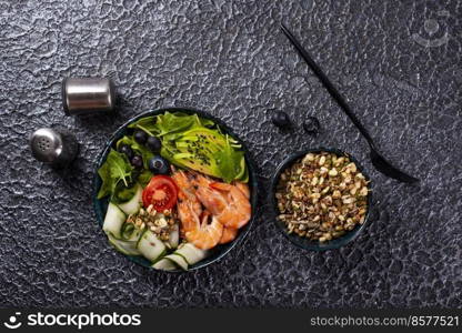 salad with avocado and shrimps in bowl, selective focus