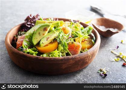 Salad with avocado with tomato and aroma spices. Salad with avocado, tomatoes and fresh greens