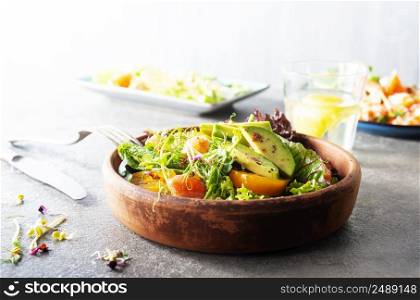 Salad with avocado with tomato and aroma spices. Salad with avocado, tomatoes and fresh greens