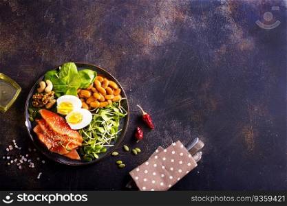 Salad with beans, salmon, egg, sprouts and nuts