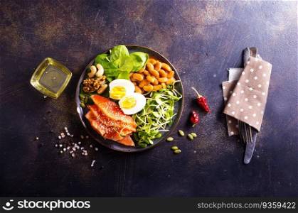 Salad with beans, salmon, egg, sprouts and nuts