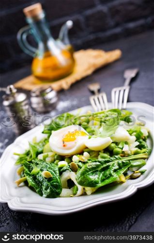 salad with boiled egg and fresh spinach on plate