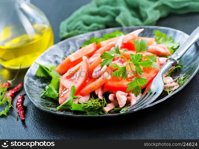 salad with calamari on plate and on a table