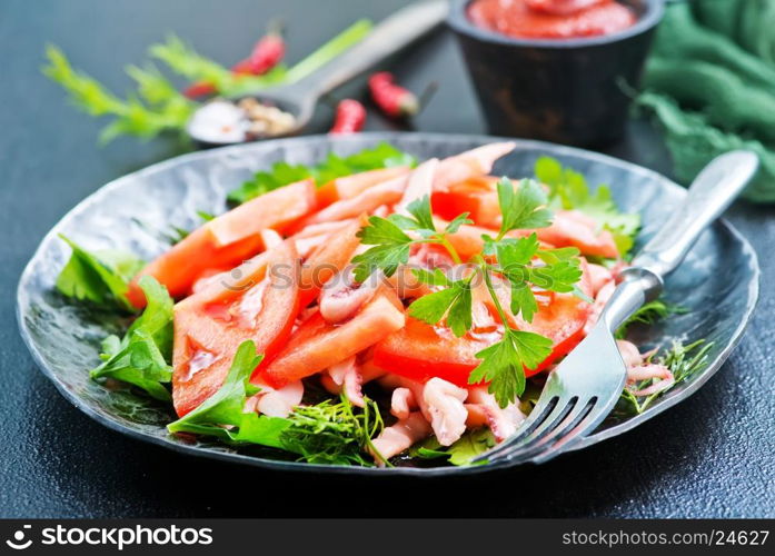 salad with calamari on plate and on a table