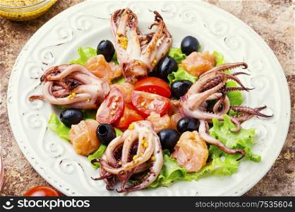 Salad with calamari, salmon and vegetables.Seafood concept. Delicious seafood salad