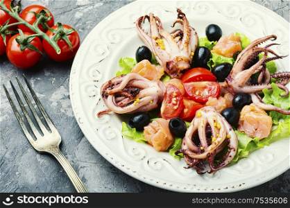 Salad with calamari, salmon and vegetables.Seafood concept. Salad with squid and seafood