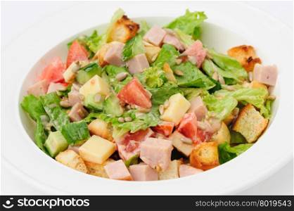 salad with cheese, ham fresh tomatoes, lettuce, sunflower seeds and crackers