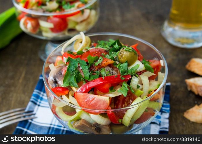 salad with cherry tomatoes, mushrooms, sweet peppers and leeks. Italian food