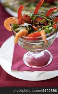 salad with cooked shrimp. healthy green salad with cooked shrimp and vegetables