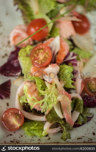 salad with cooked shrimp. healthy green salad with cooked shrimp and vegetables