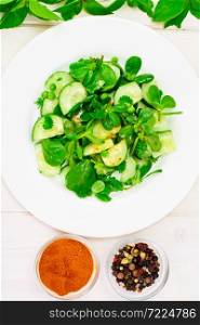Salad with Cucumber, Purslane and Green Peas on Dark Disks Studio Photo. Salad with Cucumber, Purslane and Green Peas on Dark Disks