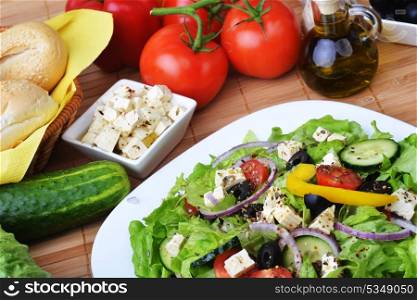 salad with feta cheese and fresh vegetables on wooden background