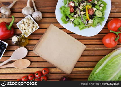 salad with feta cheese and fresh vegetables on wooden background