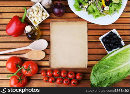 salad with feta cheese and fresh vegetables on wooden background