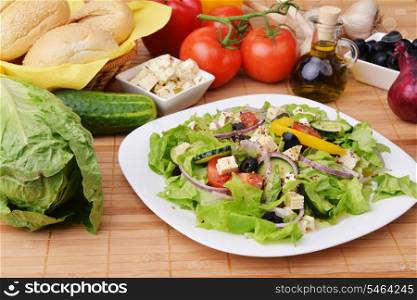 salad with feta cheese and fresh vegetables on wooden background